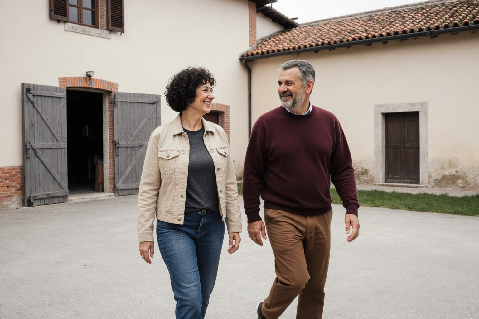 Two adults touring an Italian farm with agricultural buildings